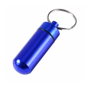 Blue aluminum pill bottle keychain, portable mini pill container detail view, outdoor EDC gear.