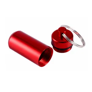 Detail view of the open red aluminum pill bottle, showing internal threads and secure keyring.