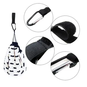 Close-up detail of stroller storage bag with carabiner and velcro strap attachments.