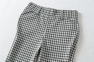 Black and white checkered women slim fit casual capri pants detail view, stretch fabric.