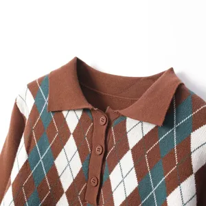 Argyle knit sweater detail, lapel collar and buttons, soft textured fabric close-up.