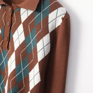 Close-up detail of women's argyle knit polo top, brown long sleeve sweater with classic diamond pattern.