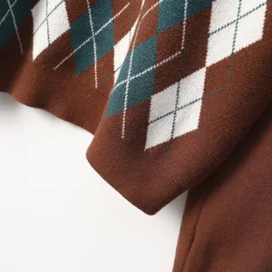 Close-up detail of stylish argyle knit sweater fabric featuring classic diamond pattern.