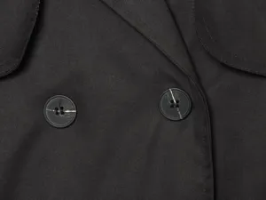 Close-up detail of women black double-breasted lapel trench coat utility jacket buttons