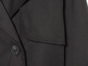 Black utility short trench coat detail, premium double-breasted lapel jacket texture.