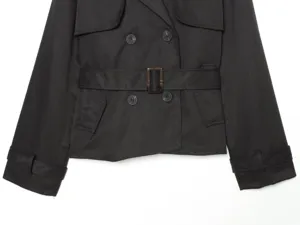 Women short double-breasted lapel trench coat jacket detail, stylish black utility outerwear piece.