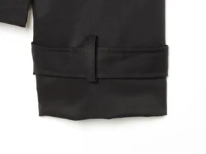 Detailed view of a black women trench coat sleeve cuff, featuring a stylish strap design.
