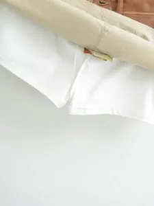 Detailed view of the contrast PU leather spliced skirt inner lining stitching quality.