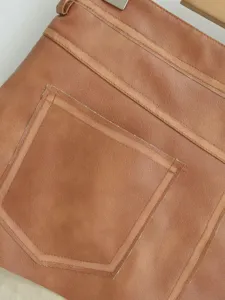 Brown PU leather mini skirt detail, vintage style short skirt with contrast stitching.