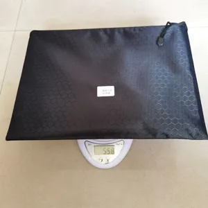 Black honeycomb textured zipper storage bag tool pouch shown on digital scale weighing 558g.