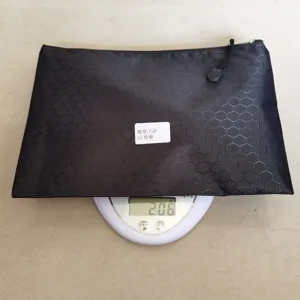 Detail view of a black hexagonal textured zipper storage bag for 21-piece weed tools.
