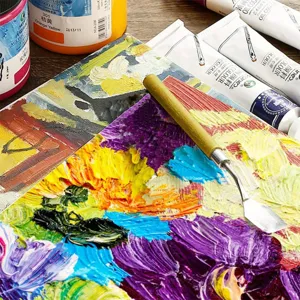 Professional artist palette knife and colorful oil paint set for creative painting and art.