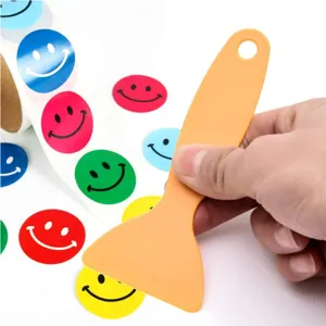 Colored vinyl smiley face dot stickers and yellow plastic weeding tool set for craft.