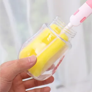 Baby bottle cleaning brush detail showing yellow sponge scrubbing inside clear bottle.