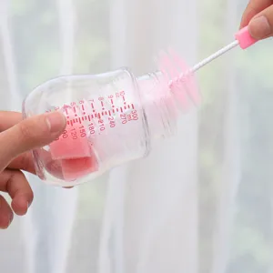 Baby bottle cleaning brush set with soft sponge head and clear capacity scale markers.