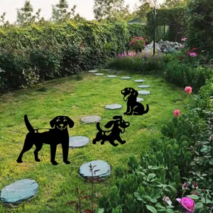 Detailed view of metal dog yard art stakes, black silhouette garden lawn decorations.