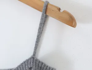 Grey knit camisole strap detail close up, minimalist fashion style clothing product detail.