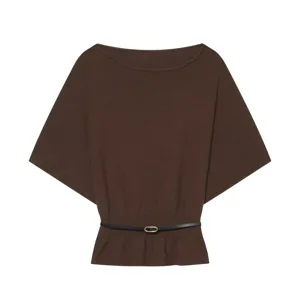 Detail of the solid color knit top with boat neck, batwing sleeves and stylish belt.