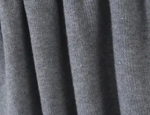 Grey knit fabric detail close-up, showing soft texture and fine ribbed pattern structure.