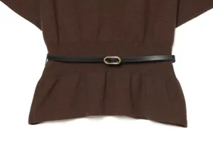Close-up detail of the elegant brown knitted top featuring a sleek black waist belt.