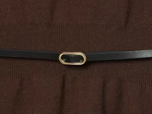 Brown knit top detail with black leather belt and gold oval buckle, elegant commuter style.