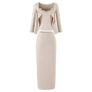 Beige ribbed knit three piece set featuring lace trim camisole cardigan and midi skirt.