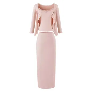 Pink knit three-piece set featuring a cardigan, lace camisole, and high waist long skirt.