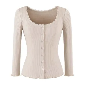 Close-up of ribbed knit cardigan featuring delicate lace trim scoop neck and front buttons.