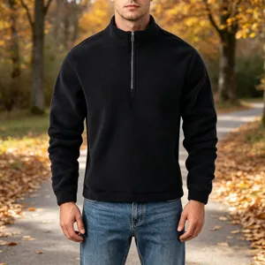 Detail view of the mens quarter-zip fleece pullover in a natural outdoor setting.