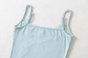 Close-up detail of light blue ribbed knit camisole with delicate lace trim and adjustable straps.