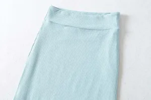 Close-up detail of light blue ribbed knit skirt waist, soft stretchy fabric texture view.