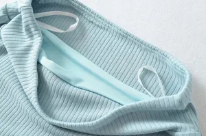 Light blue ribbed knit fabric detail, soft inner lining, fine texture, close-up view.
