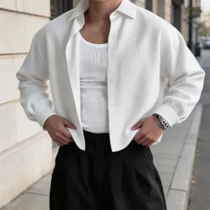 Men's textured long sleeve shirt detail shot, casual lapel design, street fashion style.
