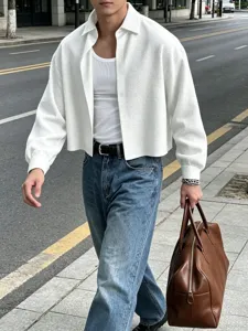 Detailed shot of a stylish men's textured cropped shirt worn in an urban street setting.