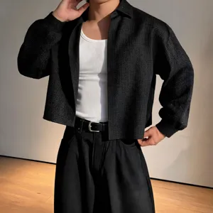 Detailed close-up view of men's textured short long-sleeve shirt with layered casual style.