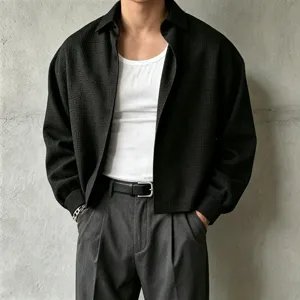 Textured black men's long sleeve shirt detail, casual lapel design for layering outfits.