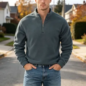 Detail view of men's quarter-zip fleece sweatshirt in slate gray, casual outdoor.