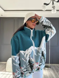 Cozy fleece zip-up jacket featuring a winter mountain and tree print with a high collar.