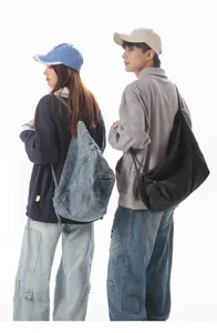 Detail shot showing casual denim shoulder bags worn by models in a clean studio setting.