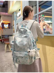 Detailed shot of a stylish light blue leaf print casual backpack for women, large capacity.