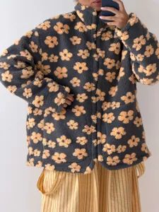 Casual floral fleece zip-up jacket detail, featuring cozy sherpa fabric and bold contrast print.