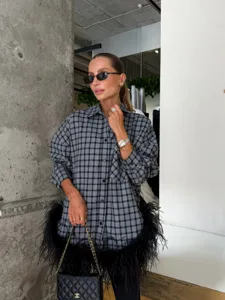 Stylish grey plaid oversized button-down shirt featuring a chic feather fringe hemline detail.