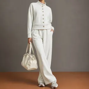 Close-up detail showing the soft white stand collar cardigan and comfortable wide leg trousers.
