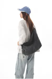 Casual denim shoulder bag detail, stylish solid color hobo crossbody bag for daily wear.