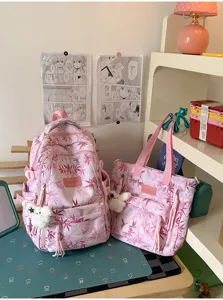 Pink printed school backpack and matching tote bag set with cute plush charms for students.