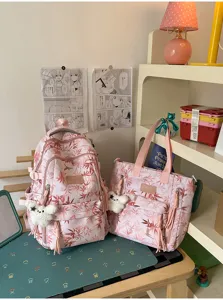 Pink leaf print student backpack and tote bag set with cute bear pendant for daily use.