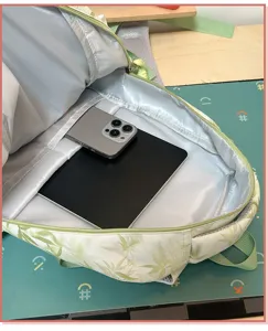 Detailed view showing the spacious interior and large capacity of the green leaf print backpack.