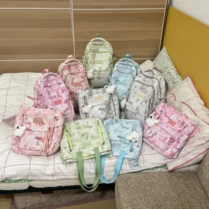 Printed backpack and tote bag set main view showing multiple color options on bed display