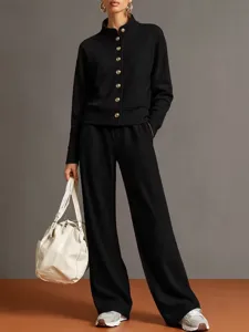 Detailed view of women's black stand collar cardigan sweatshirt and wide leg pants set.