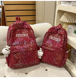 Detail view of Korean style casual school backpack with shiny design and cute fluffy pendant.